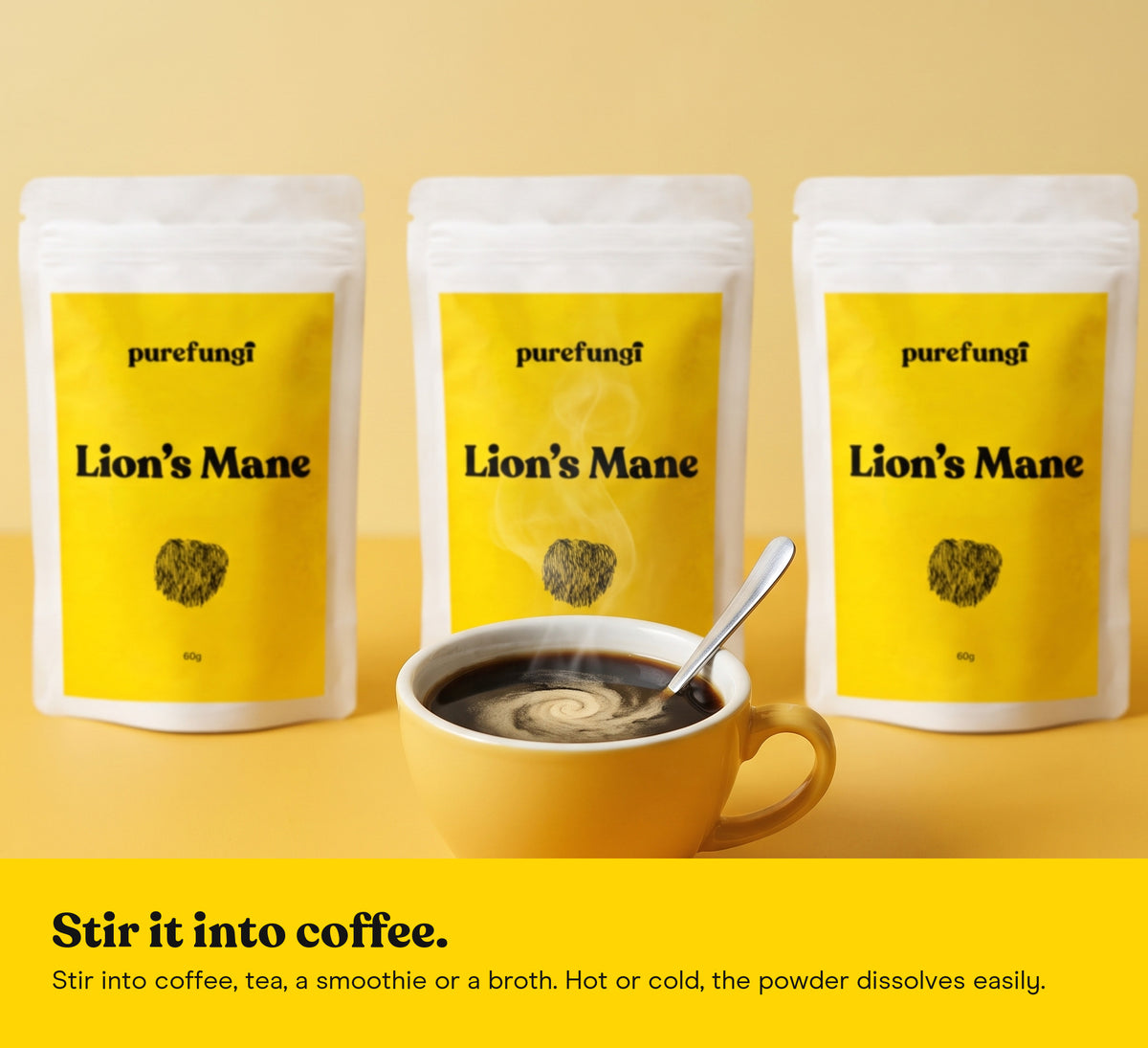 A cup of coffee with Lion's Mane powder stirred in, in front of three Lion's Mane powder pouches