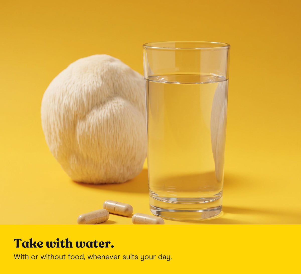 A glass of water and three Lion's Mane extract capsules, a Lion's Mane mushroom behind, on a yellow backdrop