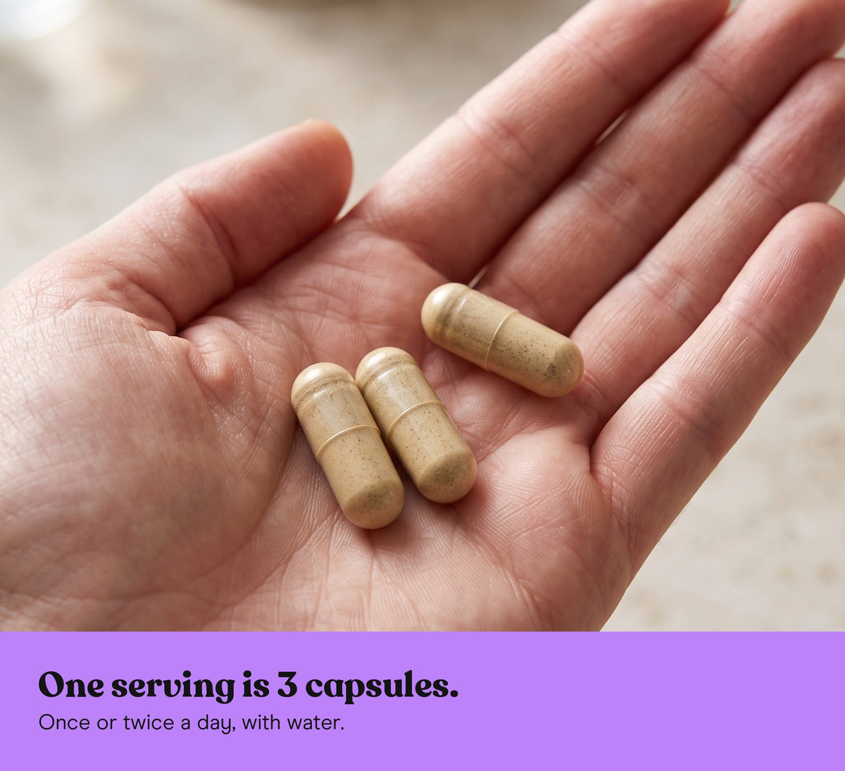 Three Reishi extract capsules in an open hand: one serving is 3 capsules, once or twice a day, with water